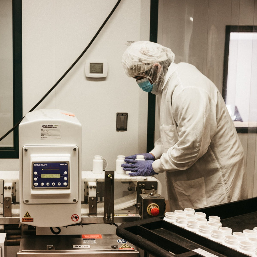 Quality check of supplement bottles on the production line